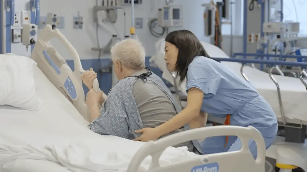 Nurse helping a patient get out of bed.